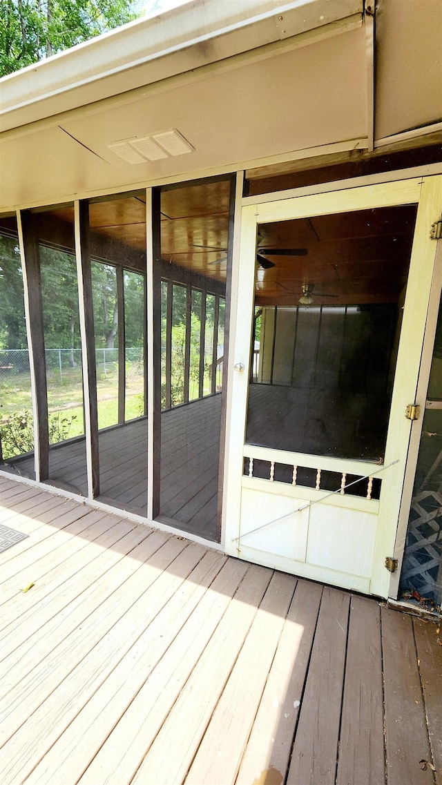 wooden terrace featuring a sunroom