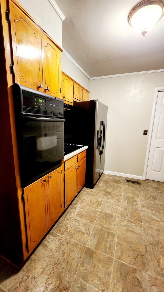 kitchen with stainless steel fridge, crown molding, and oven