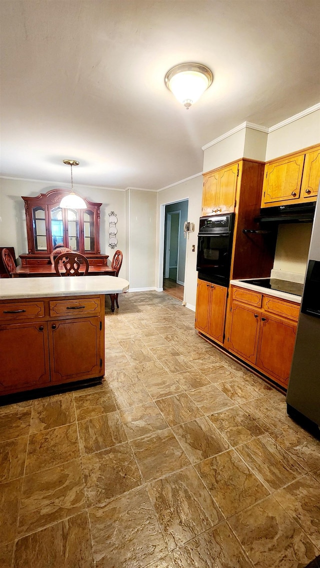 kitchen with hanging light fixtures, kitchen peninsula, stainless steel fridge, crown molding, and black oven