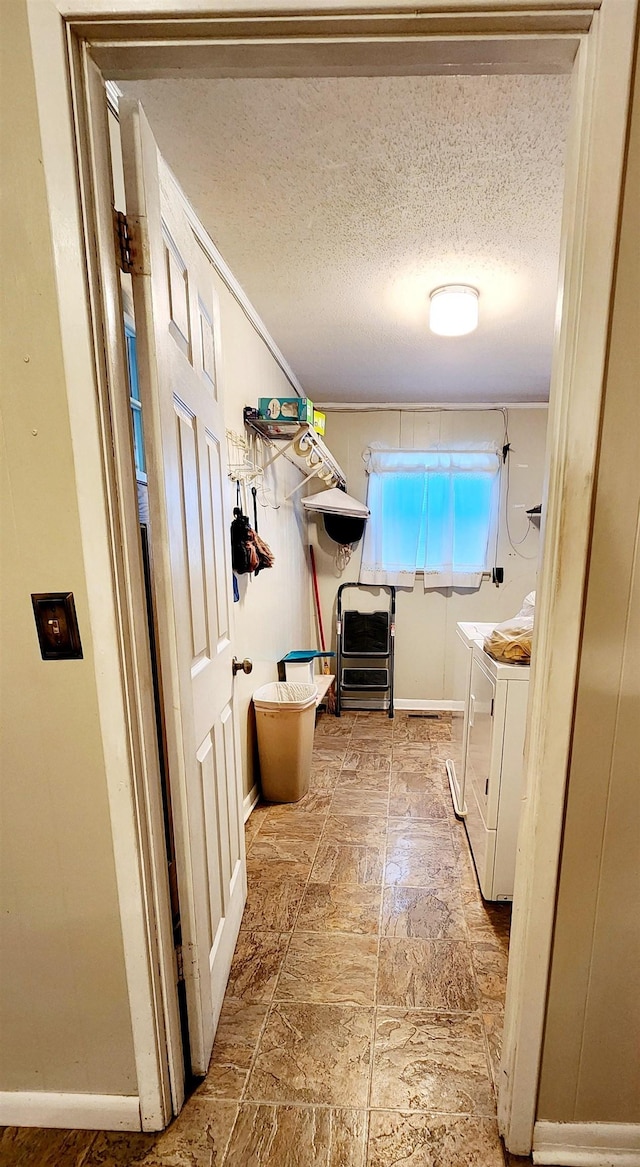 laundry room featuring washing machine and dryer and a textured ceiling