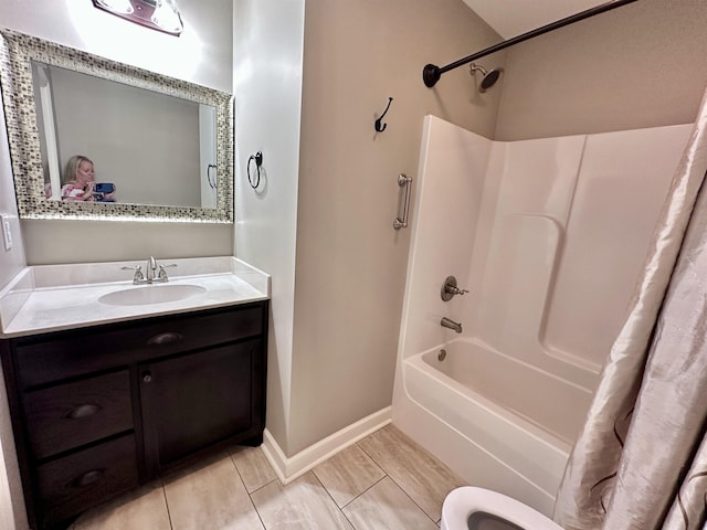  - bathroom featuring shower / bath combo, vanity, toilet, and baseboards