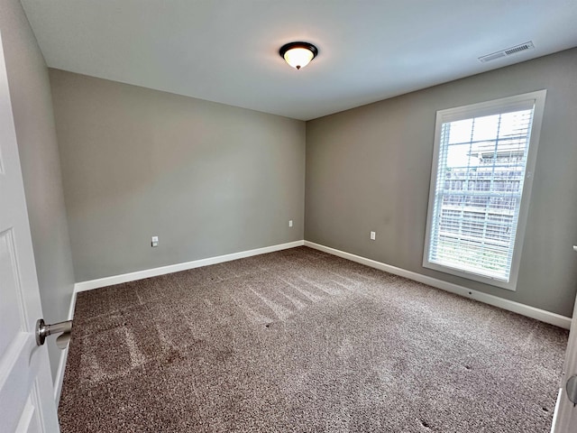  - carpeted spare room featuring baseboards