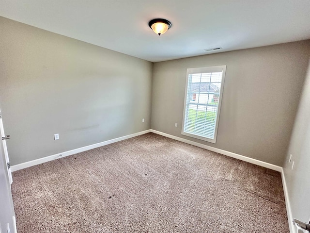  - spare room with baseboards and carpet