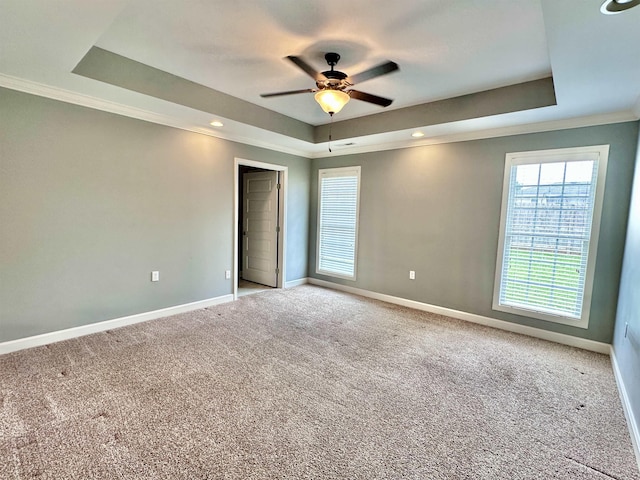  - unfurnished bedroom with a tray ceiling, baseboards, carpet flooring, ornamental molding, and recessed lighting