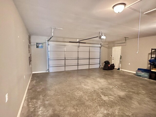  - garage featuring baseboards and a garage door opener