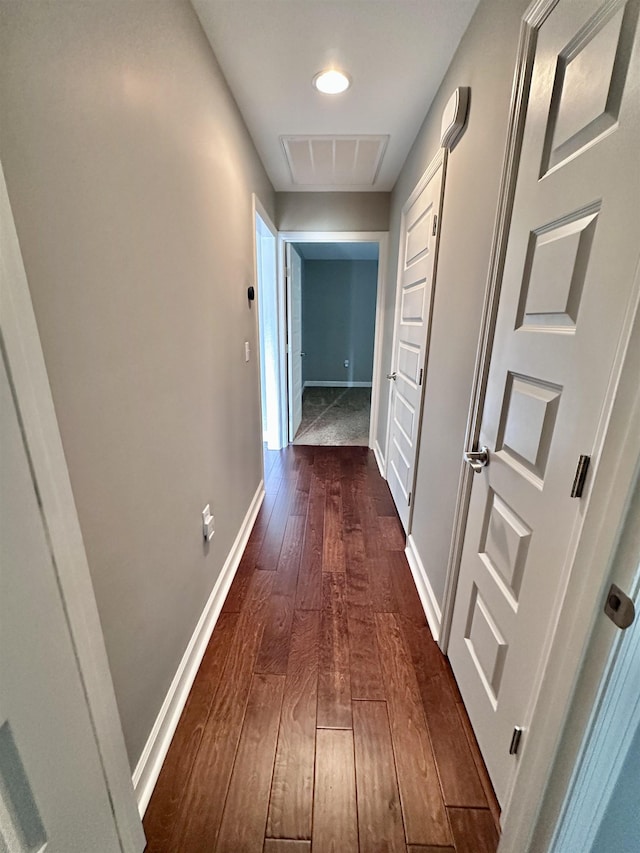  - corridor with dark wood-style floors and baseboards