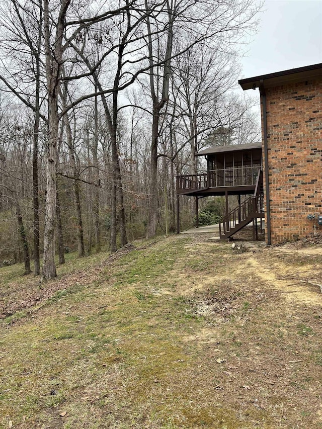 view of yard with a sunroom and stairs