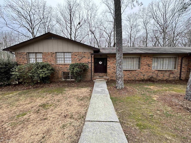 ranch-style house with brick siding and board and batten siding