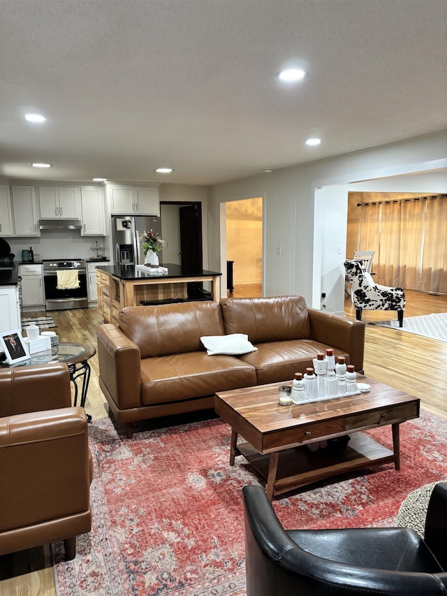 living room featuring light wood-type flooring and recessed lighting