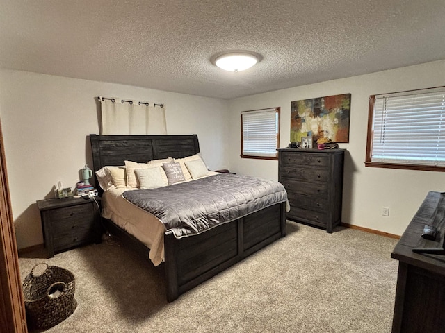 bedroom featuring baseboards, a textured ceiling, and light colored carpet