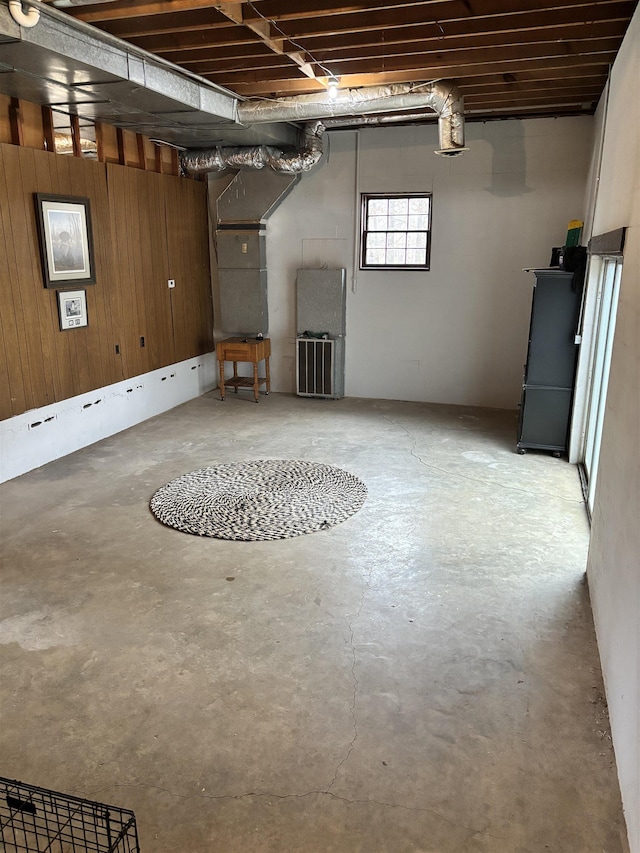 basement featuring wooden walls