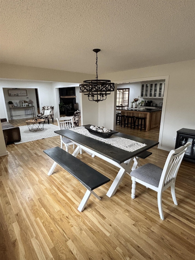 dining area featuring a textured ceiling and wood finished floors