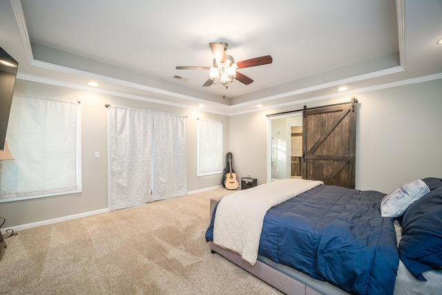 bedroom with visible vents, a barn door, carpet floors, crown molding, and a raised ceiling