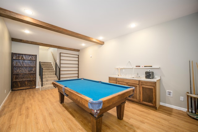 game room featuring light wood finished floors, pool table, baseboards, beam ceiling, and a sink