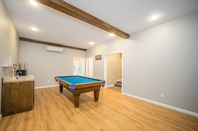 recreation room with baseboards, a wall mounted AC, recessed lighting, light wood-style floors, and beamed ceiling