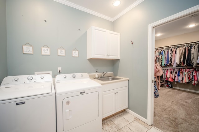 laundry room featuring light carpet, ornamental molding, washer and dryer, a sink, and cabinet space