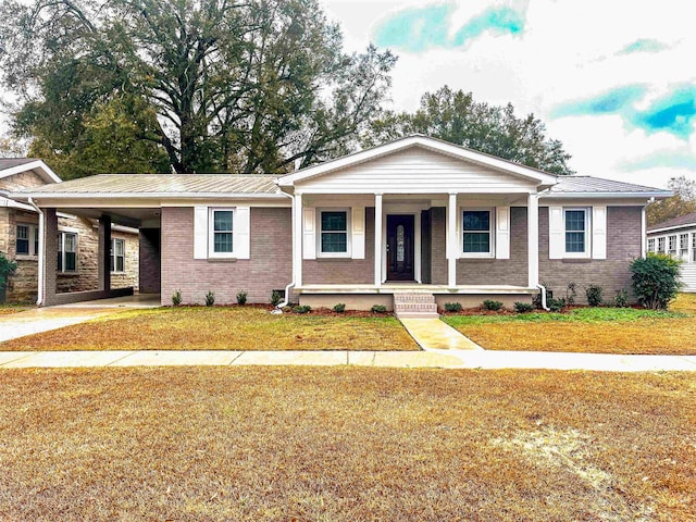 view of front of house with a front yard, a porch, and a carport