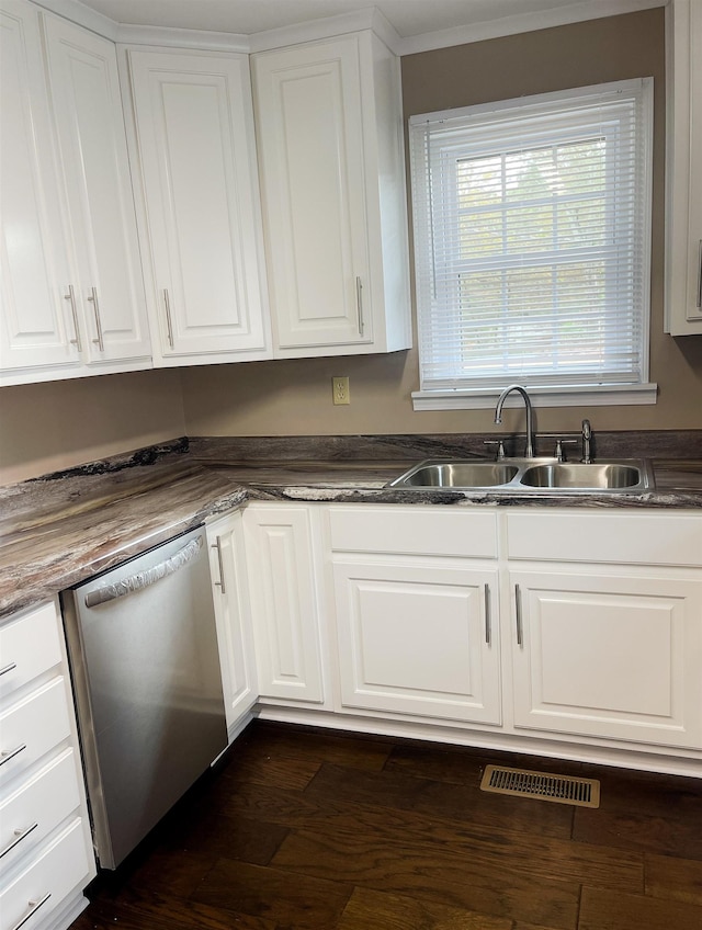 kitchen with dark wood-type flooring, sink, white cabinets, and stainless steel dishwasher