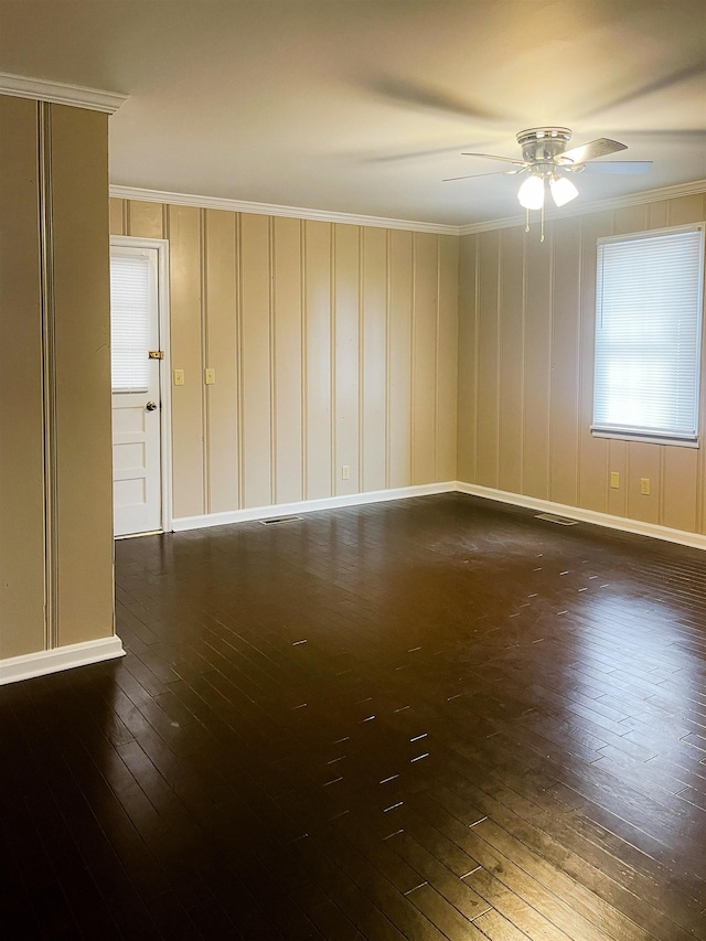 unfurnished room with ceiling fan, dark wood-type flooring, and ornamental molding