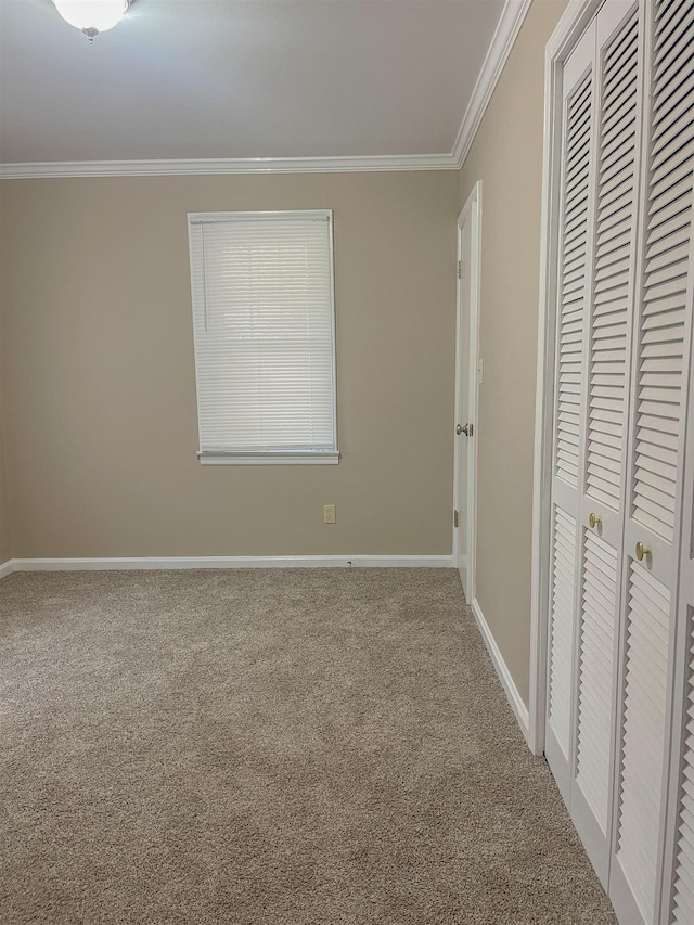 unfurnished bedroom featuring carpet flooring and ornamental molding