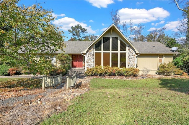  - view of front of house with a front lawn and stone siding