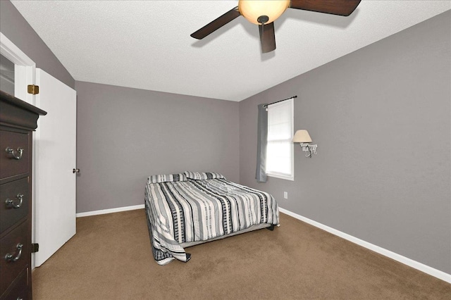  - carpeted bedroom with a ceiling fan and baseboards