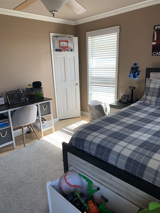 bedroom featuring baseboards, light wood-type flooring, and crown molding