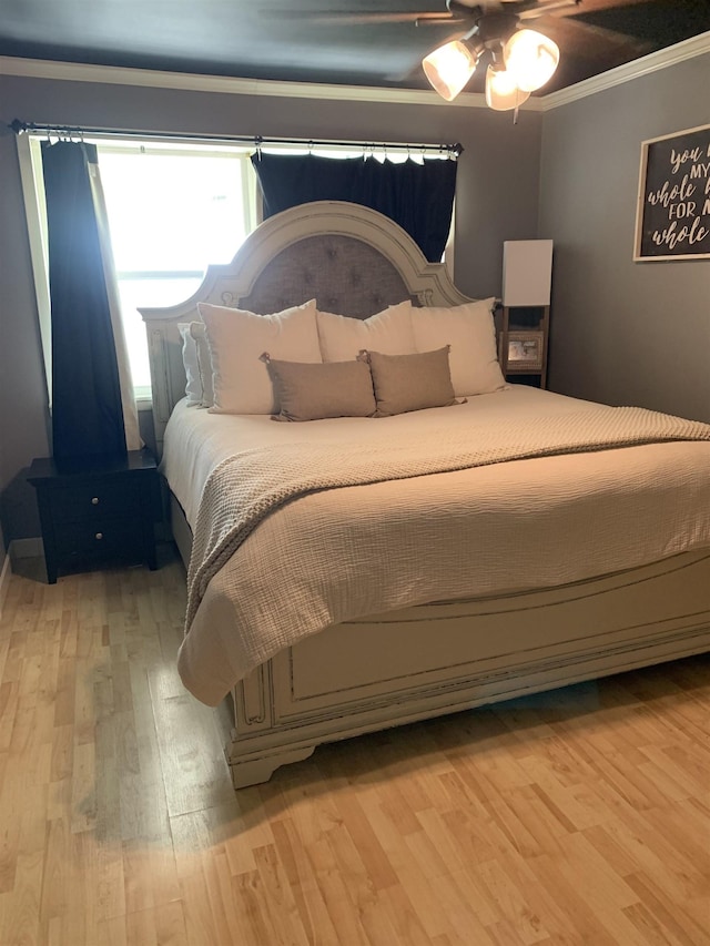 bedroom featuring ornamental molding and light wood-type flooring