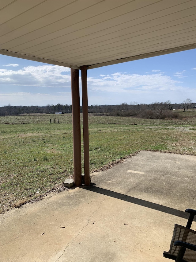 view of yard featuring a rural view and a patio