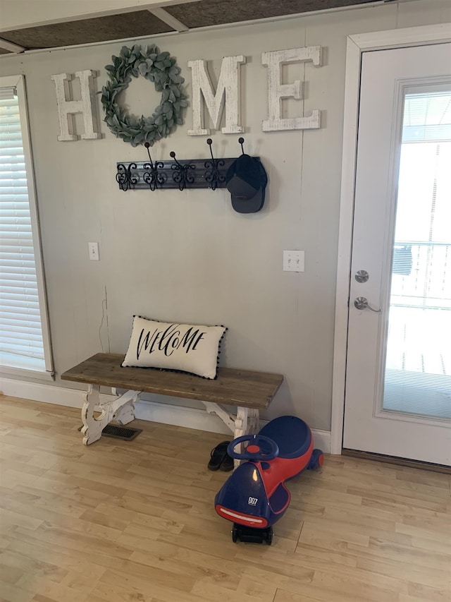 mudroom featuring light wood-style flooring and baseboards