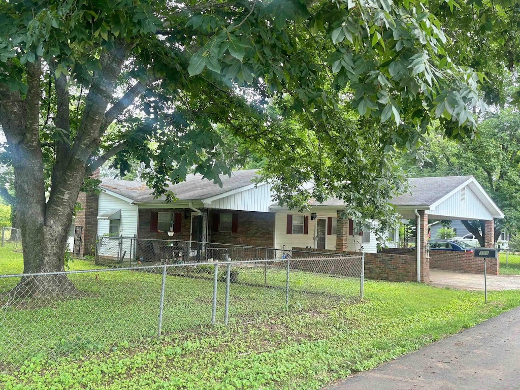  - single story home with brick siding, a carport, and covered porch
