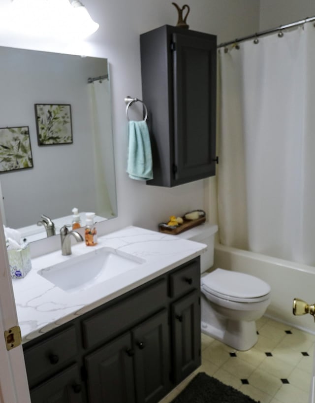 full bathroom featuring vanity, shower / bathtub combination with curtain, and toilet