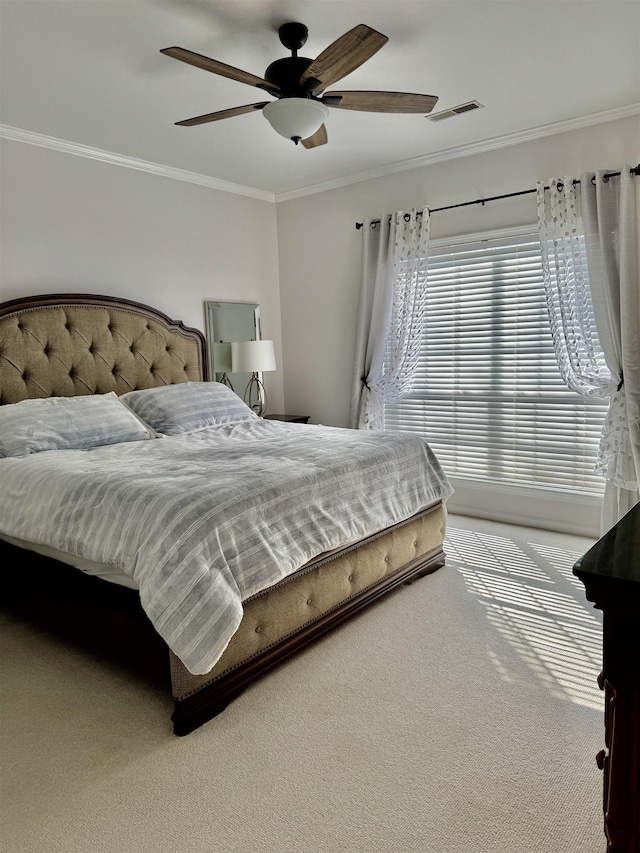 carpeted bedroom featuring crown molding and ceiling fan