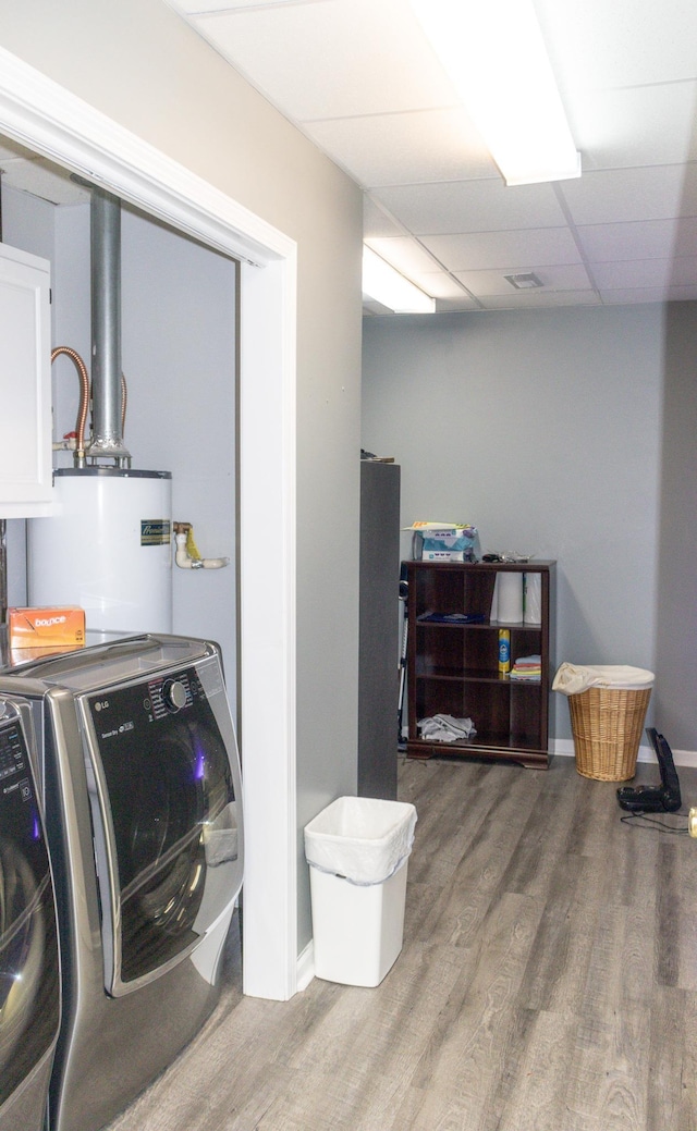 laundry room with gas water heater, hardwood / wood-style floors, and independent washer and dryer