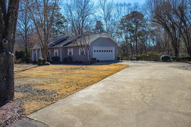 single story home featuring a garage and a front yard