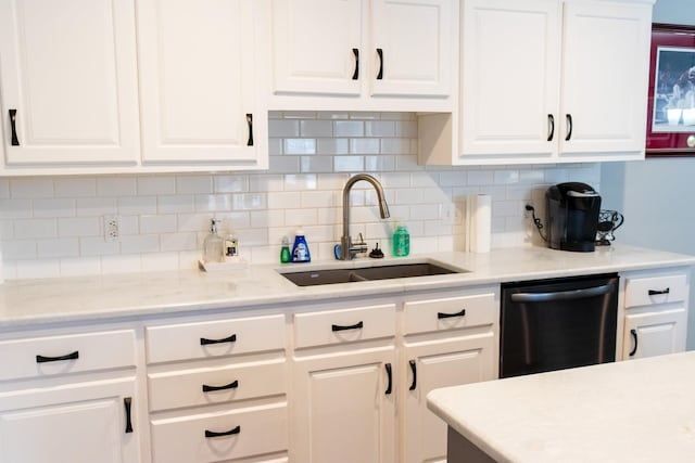 kitchen featuring sink, decorative backsplash, white cabinets, and dishwasher