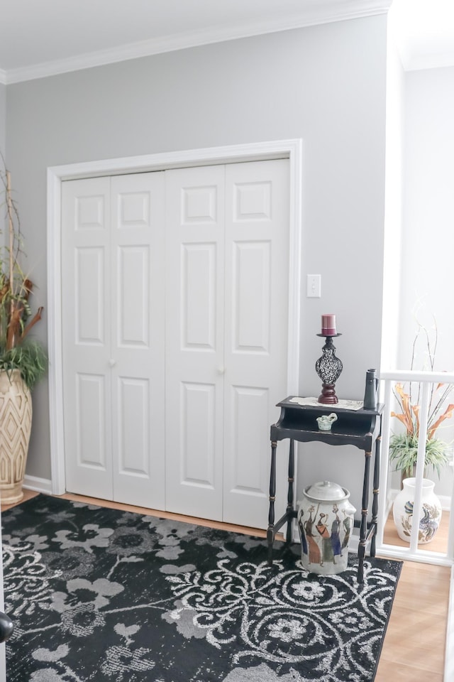 entryway featuring crown molding and wood-type flooring