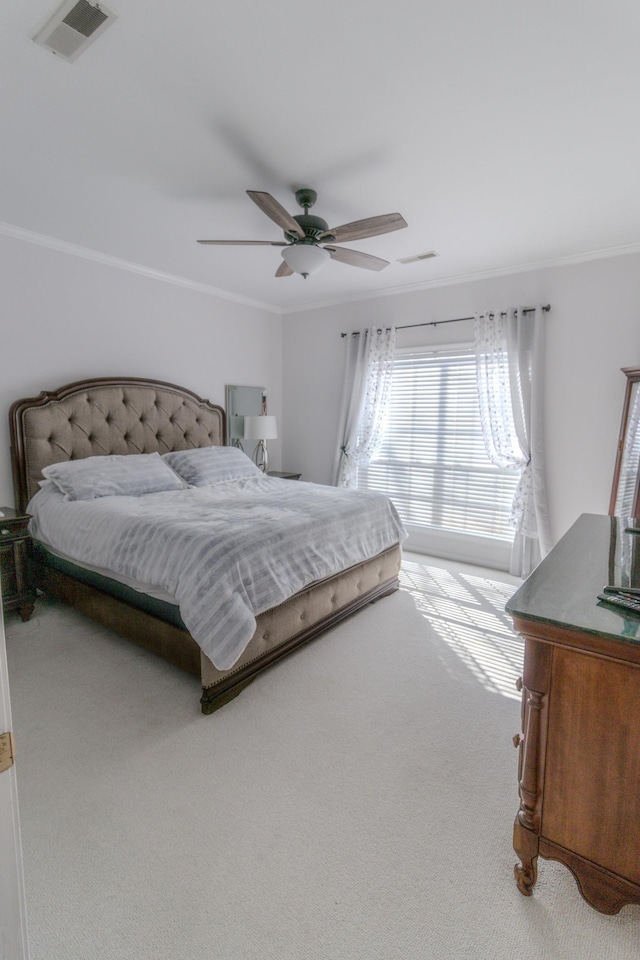 bedroom featuring ornamental molding, carpet floors, and ceiling fan