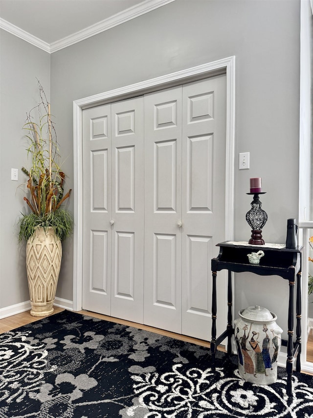 entryway featuring hardwood / wood-style floors and ornamental molding