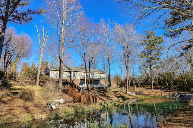 back of house with a water view