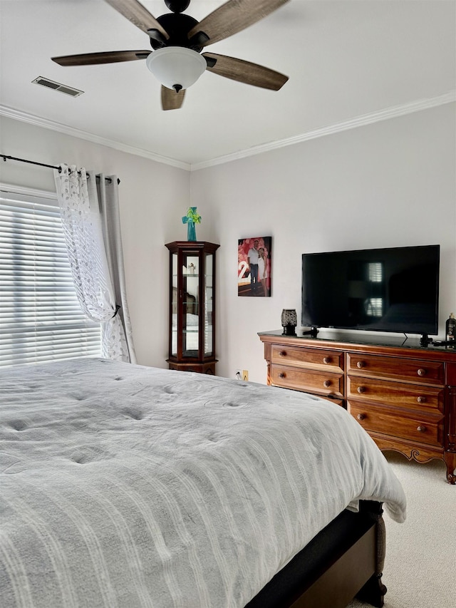 bedroom with carpet floors, ornamental molding, and ceiling fan