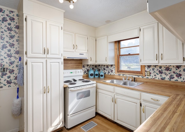 kitchen featuring a textured ceiling, white cabinetry, white electric stove, and sink