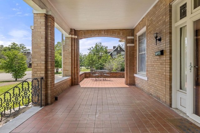 view of patio with a porch and outdoor dining space