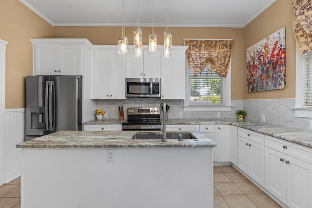 kitchen featuring a kitchen island with sink, light tile patterned flooring, appliances with stainless steel finishes, and a sink