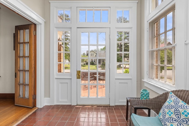 doorway to outside with baseboards and a wealth of natural light