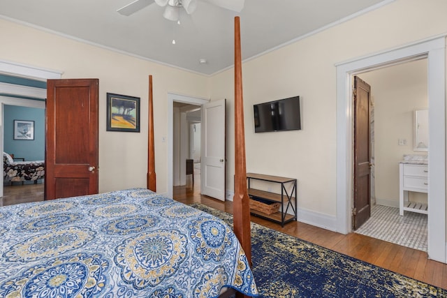 bedroom featuring ceiling fan, crown molding, baseboards, wood-type flooring, and ensuite bathroom