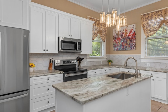 kitchen with appliances with stainless steel finishes, a center island with sink, a sink, light stone counters, and a notable chandelier