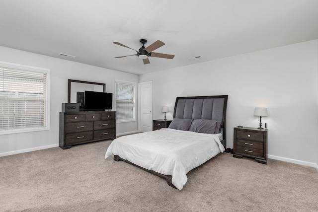 bedroom with ceiling fan and light carpet