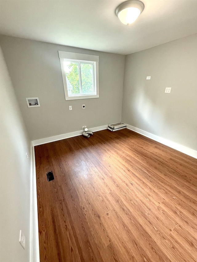  - unfurnished room with baseboards and wood finished floors