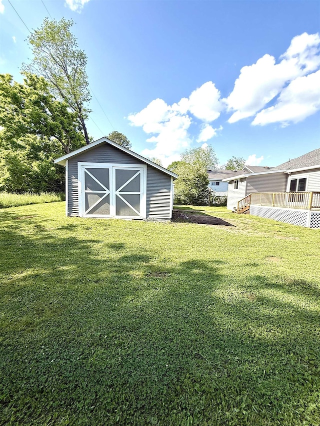  - view of yard with a storage shed, an outdoor structure, and a deck